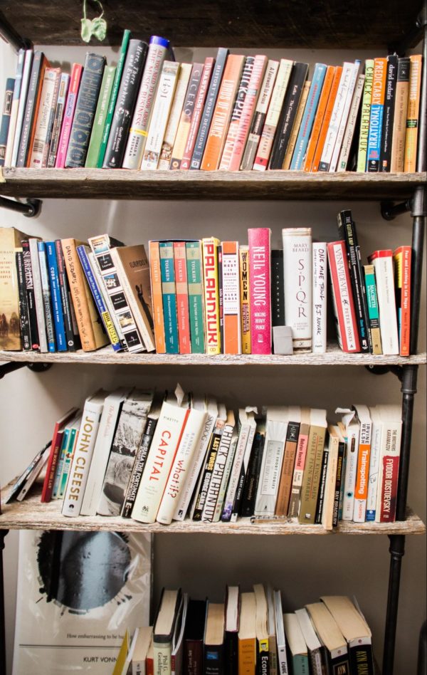 Image of a bookshelf with four rows filled with books.