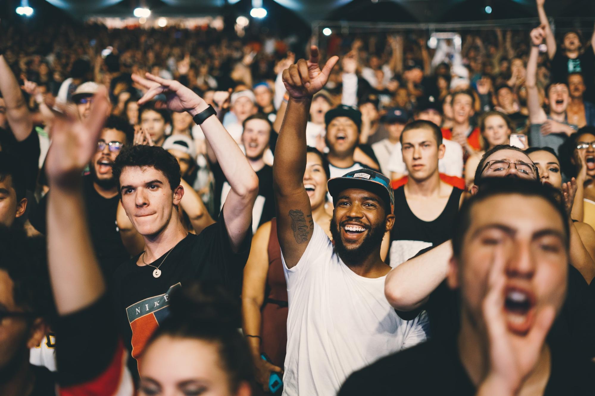 People with hands up in the air excited about social media